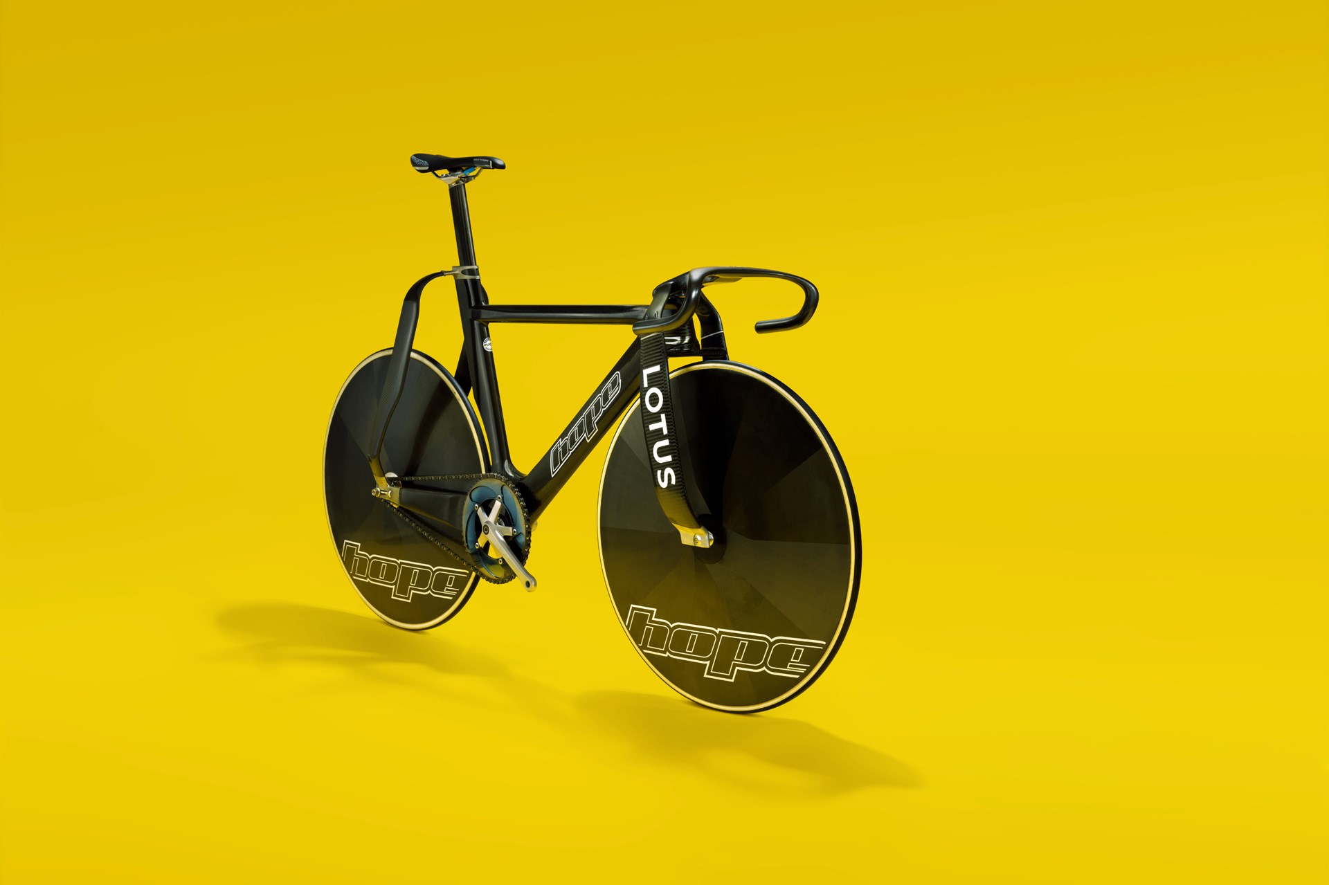 Hope Lotus HB.T Olympic track bike in black with Lotus logo on yellow studio background
